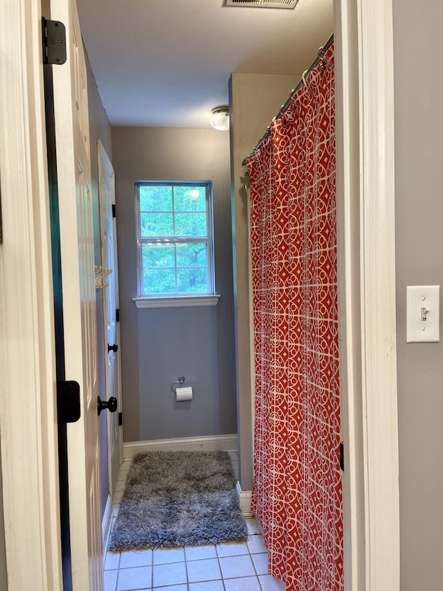 full bath with tile patterned flooring