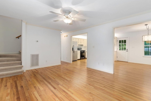 1623 Devlan Forest Ln, Signal Mountain, TN 37377 - unfurnished living room featuring crown molding, stairs, ceiling fan, light wood finished floors, and a chandelier