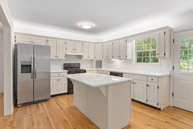 1623 Devlan Forest Ln, Signal Mountain, TN 37377 - kitchen with stainless steel fridge with ice dispenser, gas stove, under cabinet range hood, light wood-type flooring, and a center island