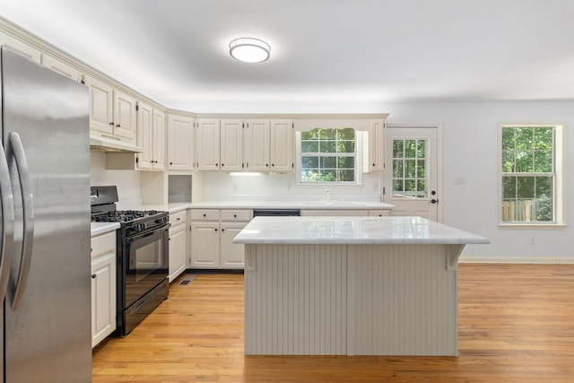 1623 Devlan Forest Ln, Signal Mountain, TN 37377 - kitchen with black appliances, light countertops, light wood finished floors, and a center island