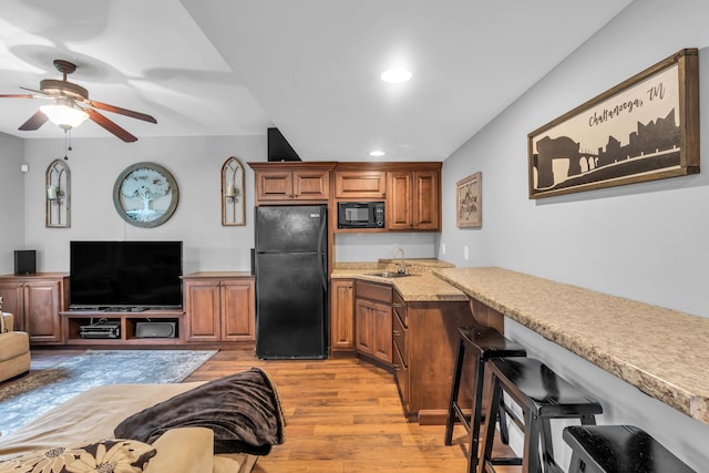 7983 Chianti Way, Chattanooga, TN 37421 - kitchen featuring black appliances, light wood-type flooring, a ceiling fan, brown cabinetry, and recessed lighting