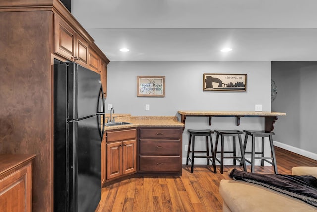 7983 Chianti Way, Chattanooga, TN 37421 - kitchen featuring freestanding refrigerator, a sink, a kitchen breakfast bar, dark wood finished floors, and recessed lighting