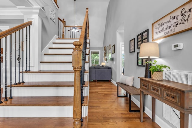 7983 Chianti Way, Chattanooga, TN 37421 - staircase featuring a high ceiling, wood finished floors, and baseboards