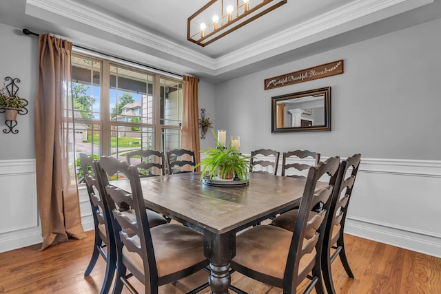 7983 Chianti Way, Chattanooga, TN 37421 - dining space featuring ornamental molding, light wood-style flooring, a chandelier, wainscoting, and a raised ceiling
