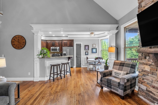 7983 Chianti Way, Chattanooga, TN 37421 - living area featuring light wood-style floors, vaulted ceiling, and decorative columns