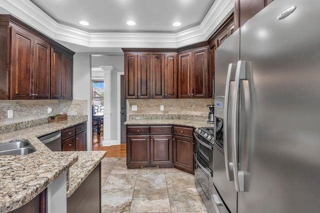 7983 Chianti Way, Chattanooga, TN 37421 - kitchen with stainless steel appliances, crown molding, backsplash, light stone countertops, and ornate columns