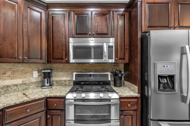 7983 Chianti Way, Chattanooga, TN 37421 - kitchen featuring stainless steel appliances, decorative backsplash, dark brown cabinets, and light stone counters