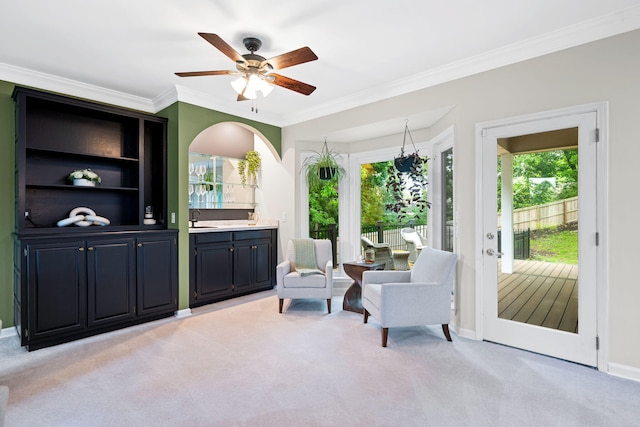 9416 Royal Mountain Dr, Chattanooga, TN 37421 - living area featuring ceiling fan, light carpet, crown molding, baseboards, and arched walkways