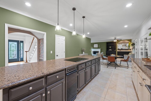 9416 Royal Mountain Dr, Chattanooga, TN 37421 - kitchen with crown molding, a fireplace, a ceiling fan, black electric stovetop, and light stone counters