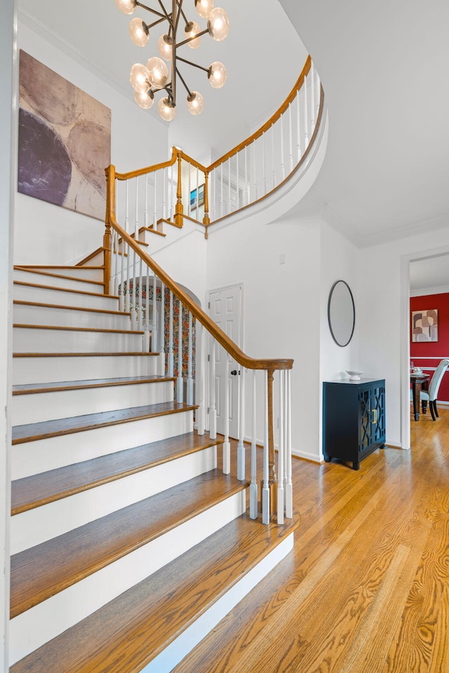 9416 Royal Mountain Dr, Chattanooga, TN 37421 - staircase with wood finished floors, a chandelier, and a towering ceiling