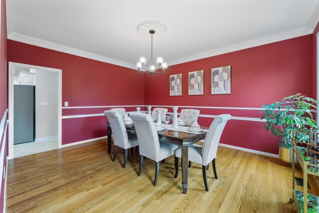 9416 Royal Mountain Dr, Chattanooga, TN 37421 - dining area featuring baseboards, wood finished floors, a chandelier, and crown molding