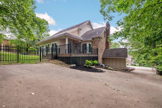 9416 Royal Mountain Dr, Chattanooga, TN 37421 - view of side of property with a storage shed, fence, a chimney, an outbuilding, and brick siding