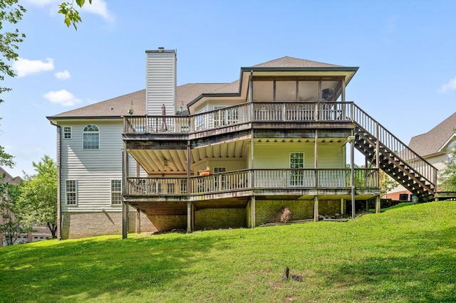 back of property featuring a deck, a lawn, a chimney, and stairs