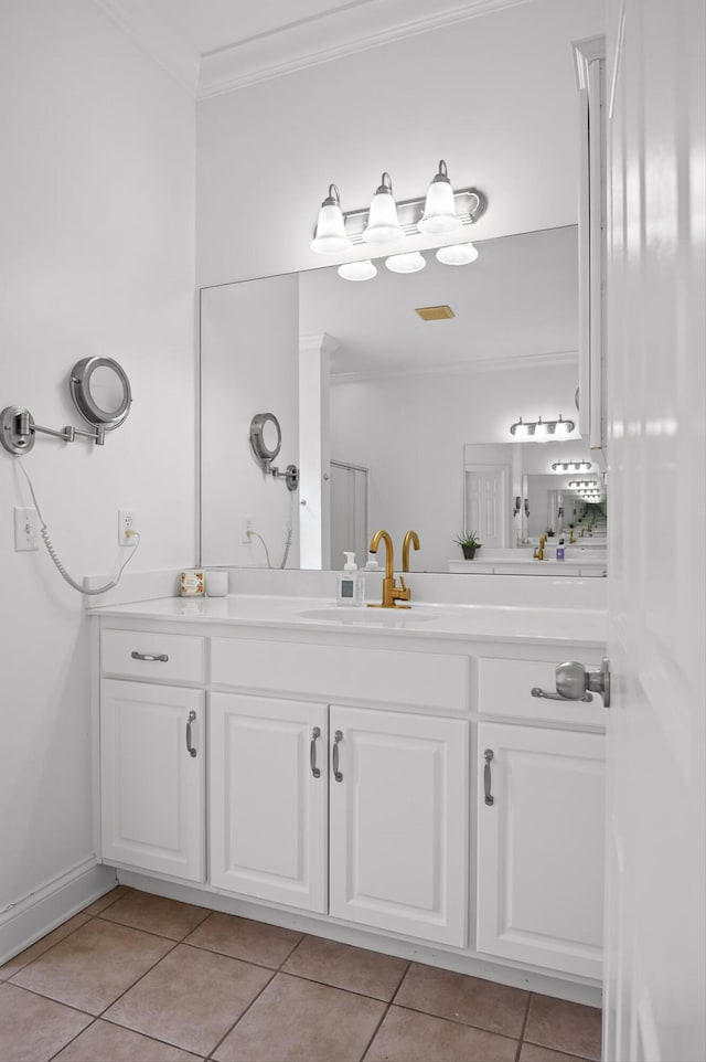 bathroom with crown molding, tile patterned floors, and vanity