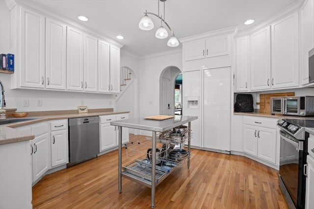 kitchen featuring stainless steel dishwasher, range with electric stovetop, built in fridge, a sink, and arched walkways