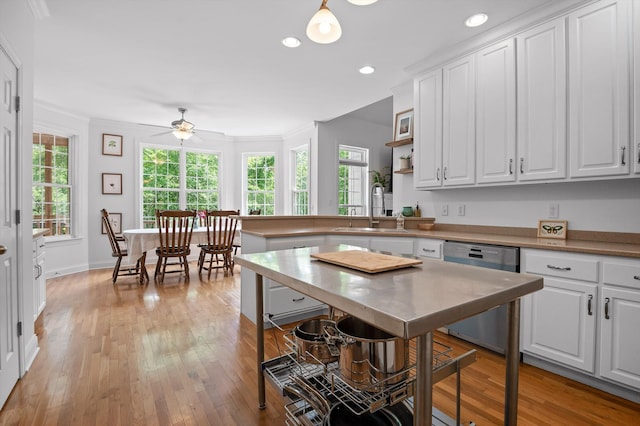 kitchen with stainless steel dishwasher, a sink, white cabinetry, a ceiling fan, and light wood-type flooring