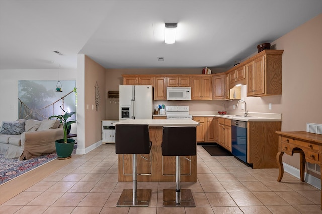 kitchen with white appliances, a sink, light countertops, a kitchen island, and light tile patterned floors