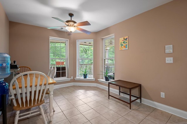 dining area featuring light tile patterned floors, baseboards, and ceiling fan