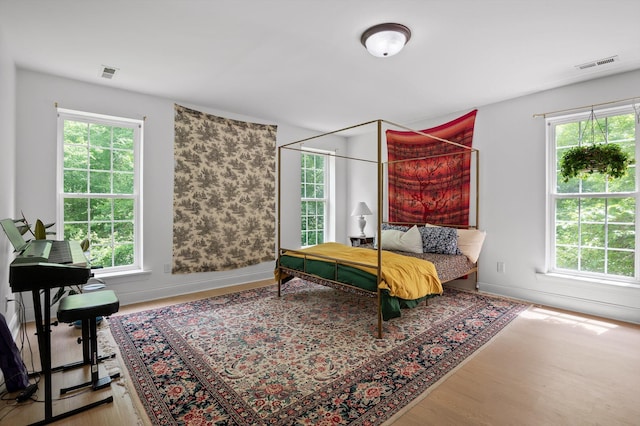 bedroom with wood finished floors and baseboards