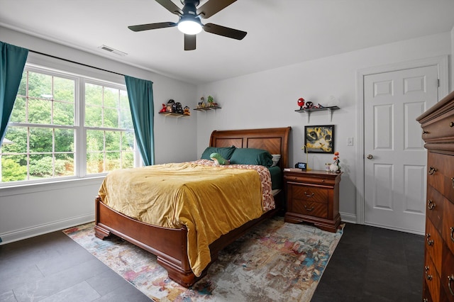 bedroom featuring multiple windows, baseboards, and a ceiling fan