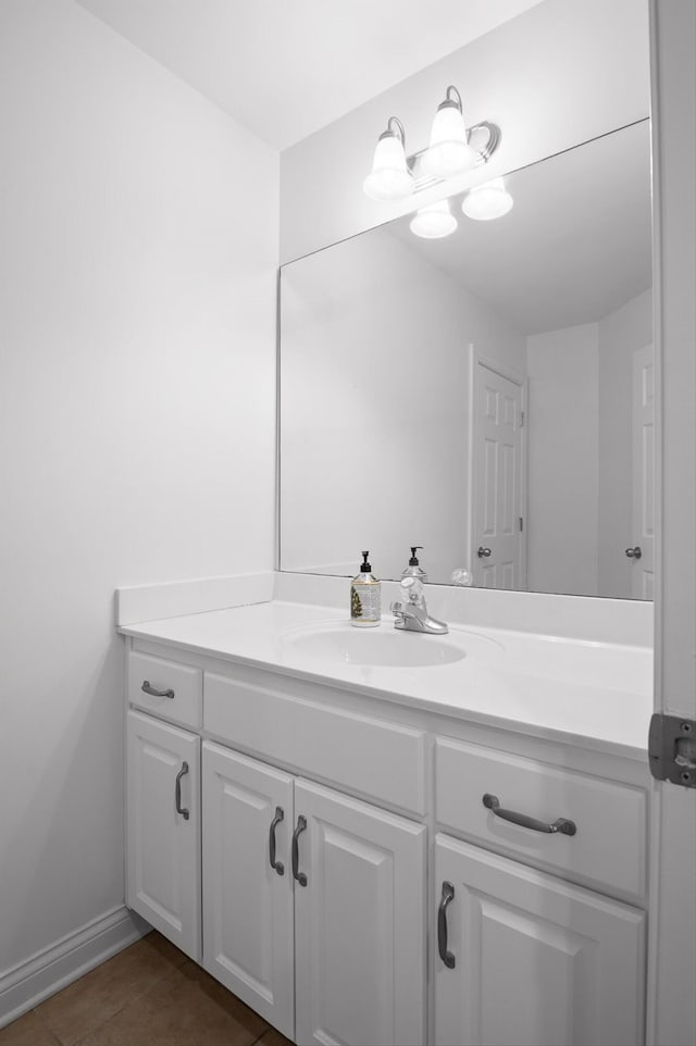 bathroom with vanity, baseboards, and tile patterned floors