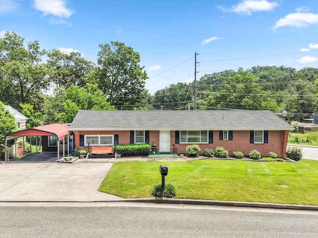 3502 Oak Ridge Dr, Chattanooga, TN 37415 - ranch-style house featuring concrete driveway, a detached carport, brick siding, a front lawn, and a shingled roof