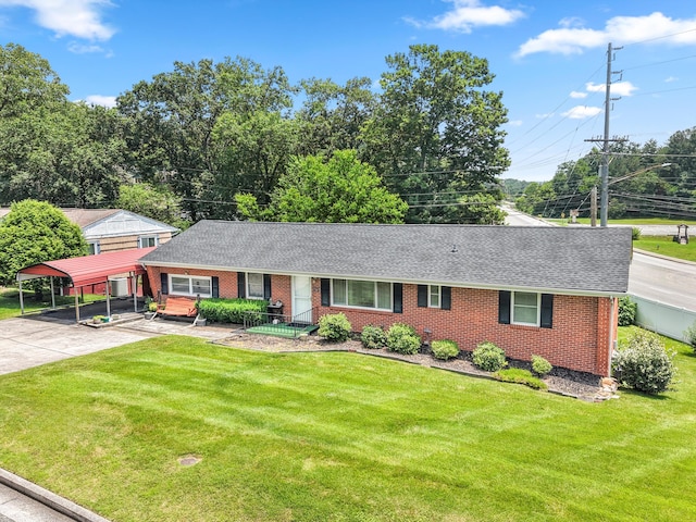 3502 Oak Ridge Dr, Chattanooga, TN 37415 - view of front facade featuring brick siding, a shingled roof, a front lawn, and a detached carport