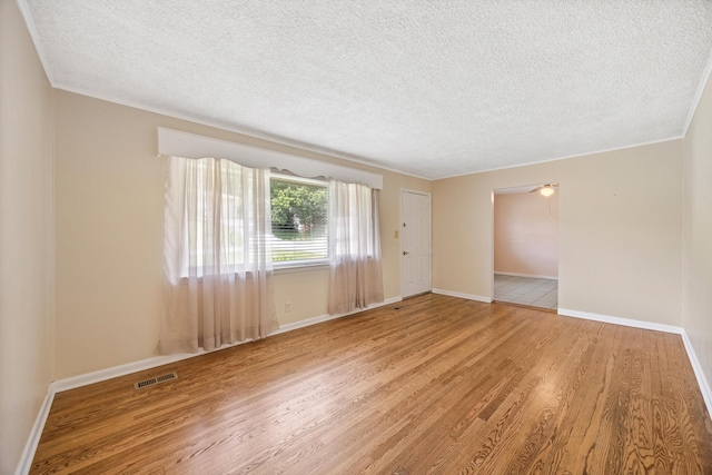 3502 Oak Ridge Dr, Chattanooga, TN 37415 - spare room featuring wood finished floors, a textured ceiling, and crown molding