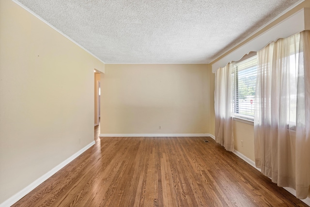 3502 Oak Ridge Dr, Chattanooga, TN 37415 - empty room with a textured ceiling, wood finished floors, and crown molding