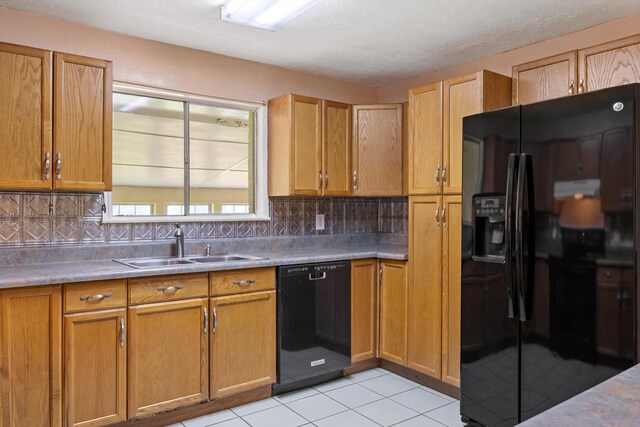 3502 Oak Ridge Dr, Chattanooga, TN 37415 - kitchen with black appliances, tasteful backsplash, light tile patterned floors, light countertops, and brown cabinetry
