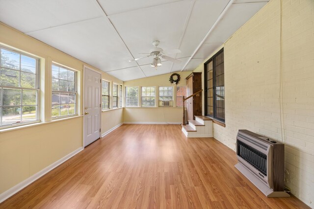 3502 Oak Ridge Dr, Chattanooga, TN 37415 - unfurnished sunroom featuring heating unit, wood finished floors, vaulted ceiling, brick wall, and cooling unit