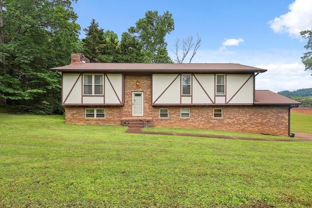 7470 Twin Brook Dr, Chattanooga, TN 37421 - view of front of home with a chimney, a front yard, brick siding, and stucco siding