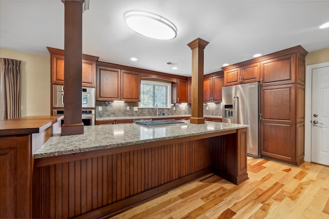 7470 Twin Brook Dr, Chattanooga, TN 37421 - kitchen featuring decorative columns, appliances with stainless steel finishes, tasteful backsplash, light wood-style floors, and recessed lighting