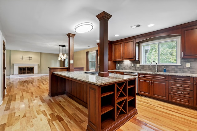 7470 Twin Brook Dr, Chattanooga, TN 37421 - kitchen featuring decorative columns, a sink, tasteful backsplash, light wood-style flooring, and open floor plan