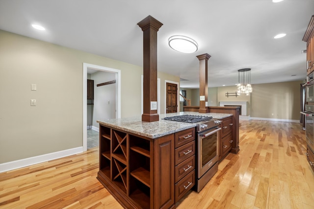 7470 Twin Brook Dr, Chattanooga, TN 37421 - kitchen with ornate columns, stainless steel appliances, open shelves, light wood-type flooring, and baseboards
