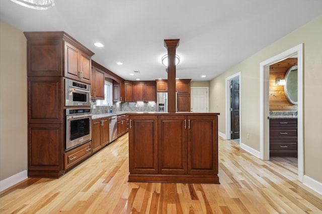 7470 Twin Brook Dr, Chattanooga, TN 37421 - kitchen with appliances with stainless steel finishes, light wood finished floors, backsplash, baseboards, and recessed lighting