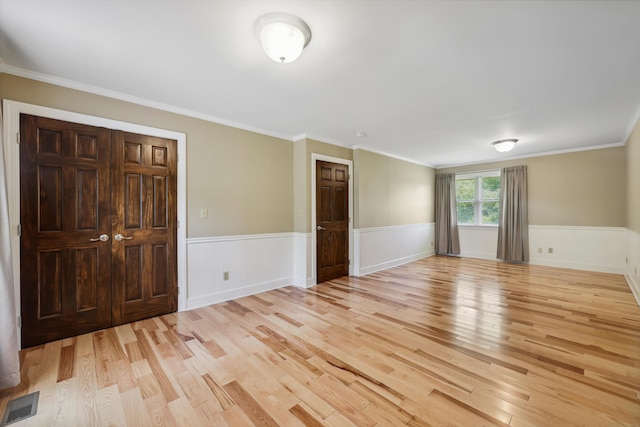 7470 Twin Brook Dr, Chattanooga, TN 37421 - spare room featuring light wood-type flooring, wainscoting, and crown molding