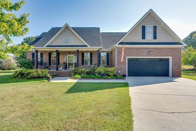 view of front of house featuring covered porch, driveway, a front yard, brick siding, and an attached garage