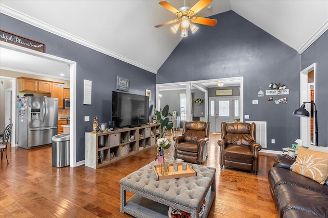 living area featuring a ceiling fan, wood finished floors, high vaulted ceiling, ornamental molding, and baseboards
