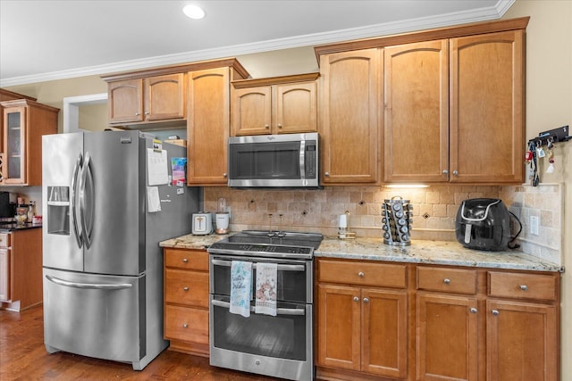 kitchen featuring stainless steel appliances, dark wood finished floors, tasteful backsplash, crown molding, and glass insert cabinets