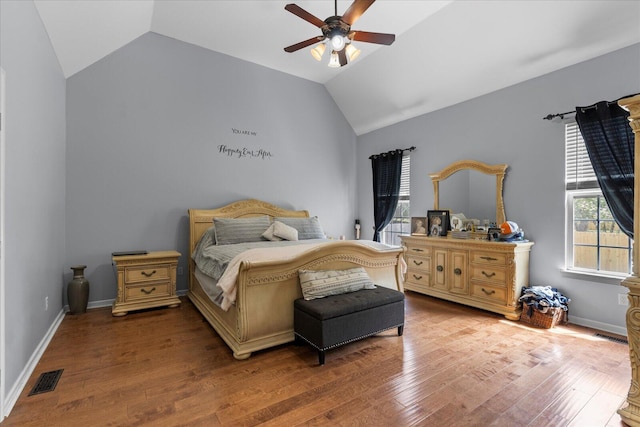 bedroom featuring lofted ceiling, wood finished floors, a ceiling fan, and baseboards