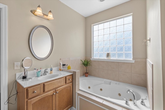 bathroom with vanity and a jetted tub