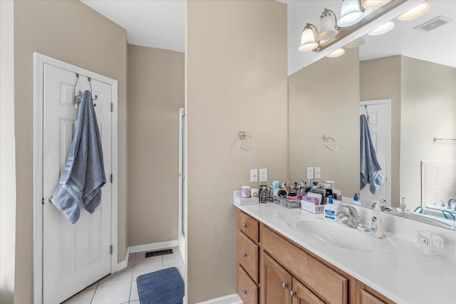 bathroom with tile patterned floors, vanity, and baseboards