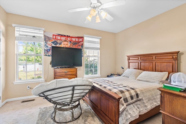 carpeted bedroom featuring baseboards and a ceiling fan