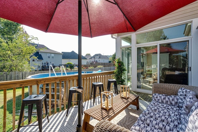 wooden deck with a fenced backyard and a residential view