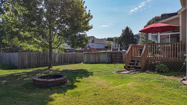 view of yard featuring an outdoor fire pit and a wooden deck
