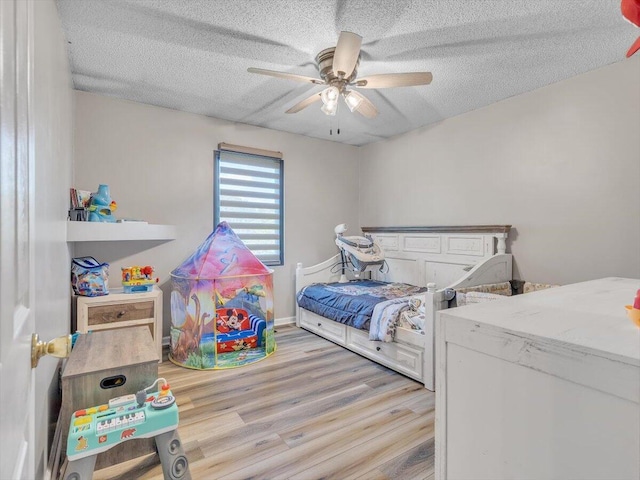 123 Paddle Wheel Ct, Cohutta, GA 30710 - bedroom with wood finished floors, a textured ceiling, and ceiling fan
