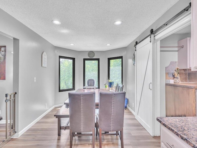 123 Paddle Wheel Ct, Cohutta, GA 30710 - dining space with a barn door, light wood-style floors, a textured ceiling, baseboards, and recessed lighting