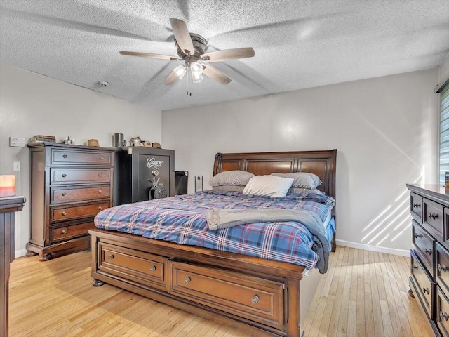 123 Paddle Wheel Ct, Cohutta, GA 30710 - bedroom with light wood-style floors, a textured ceiling, baseboards, and a ceiling fan