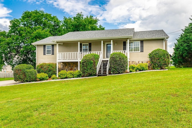 view of front of property featuring covered porch, stairway, a front lawn, stone siding, and roof with shingles
